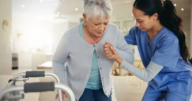 Senior woman, person with disability and nurse for help to couch, walking frame and handholding. Healthcare or elderly for medical, patient rehabilitation and injury for therapy, support or recovery
